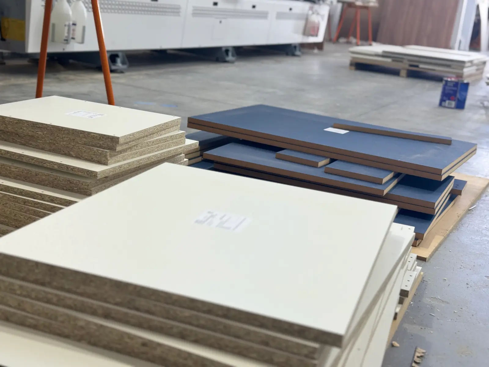 Cut and labelled cabinetry parts stacked on the factory floor at Coastal Cut To Size